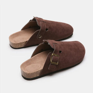 Chocolate suede clog slides with cork sole and adjustable buckle strap.