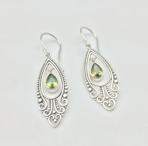 Silver filigree drop earrings with pear-shaped peridot stones.