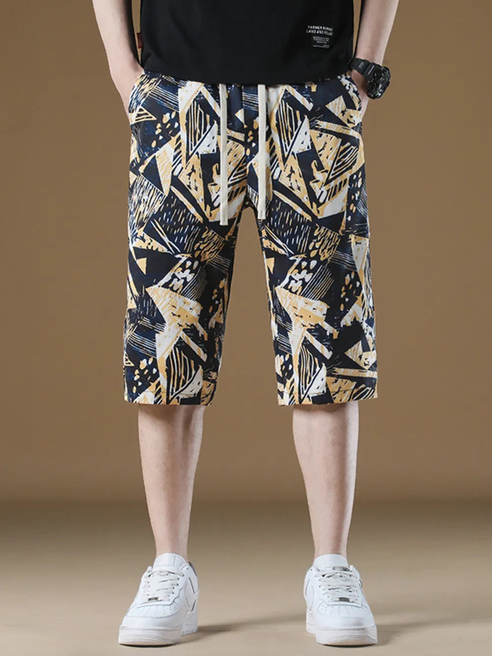 Men's geometric print drawstring chino shorts in navy, yellow, and white abstract pattern.