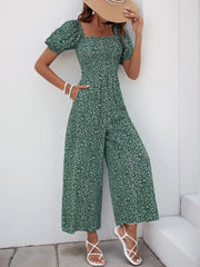 Dark Green floral smocked bodice wide-leg jumpsuit with puff sleeves and pockets.
