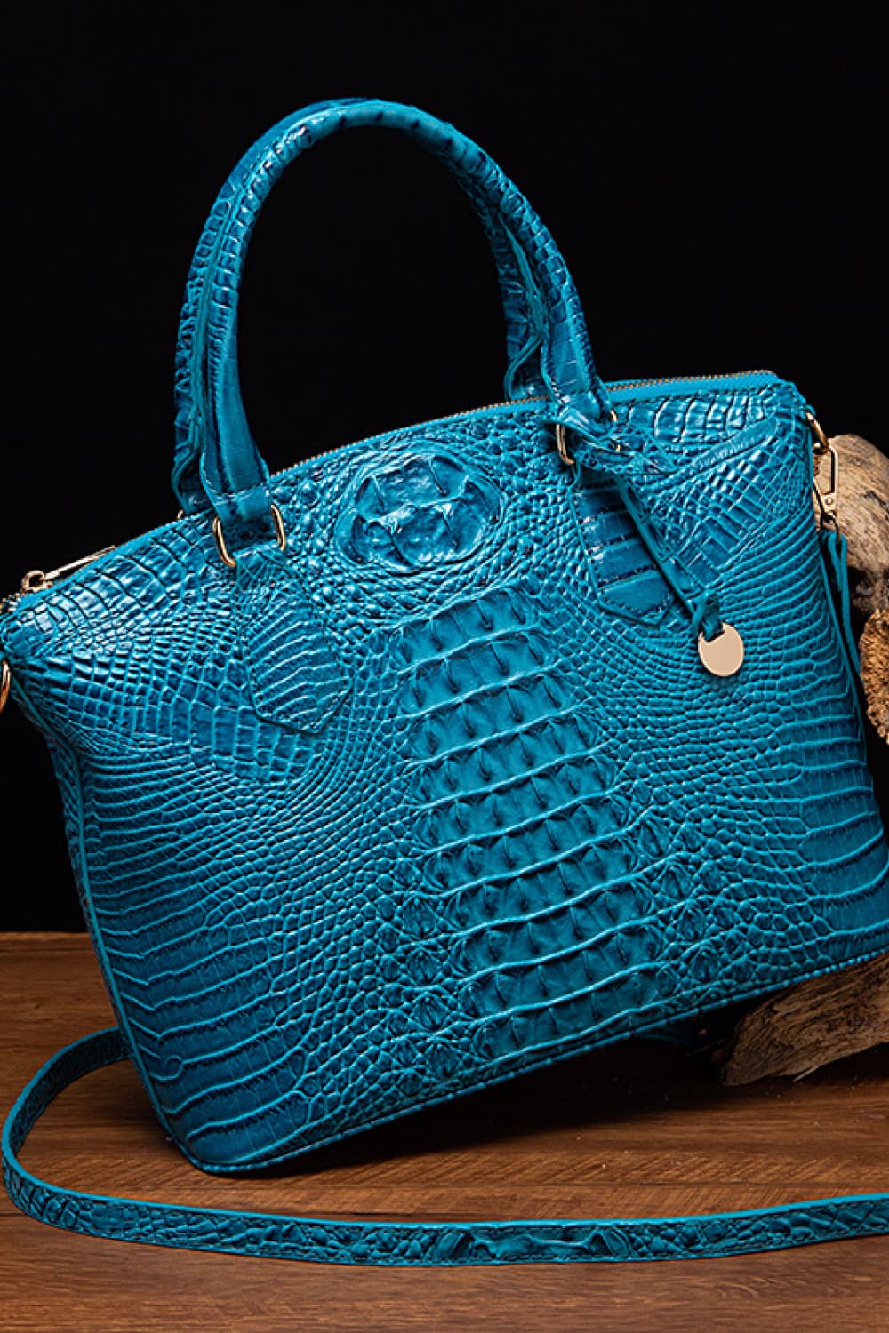 Sky blue crocodile embossed satchel with top handle and crossbody strap.