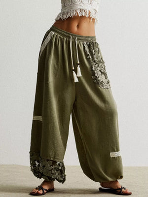 Moss harem pants with drawstring, lace trim, and floral embroidery detail.