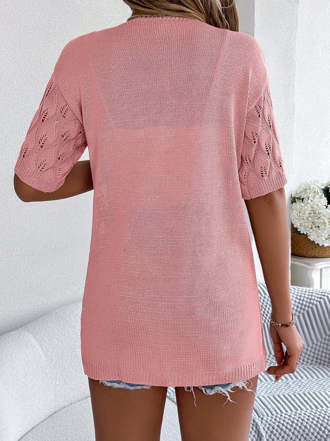 Open-knit leaf motif short sleeve cardigan in watermelon pink acrylic with a relaxed fit.