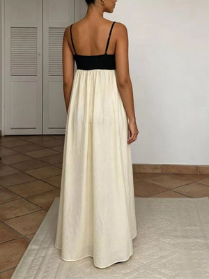 Elegant two-tone maxi dress with spaghetti straps, black bodice, cream skirt.