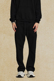 Black relaxed fit joggers with drawstring waist and pockets.