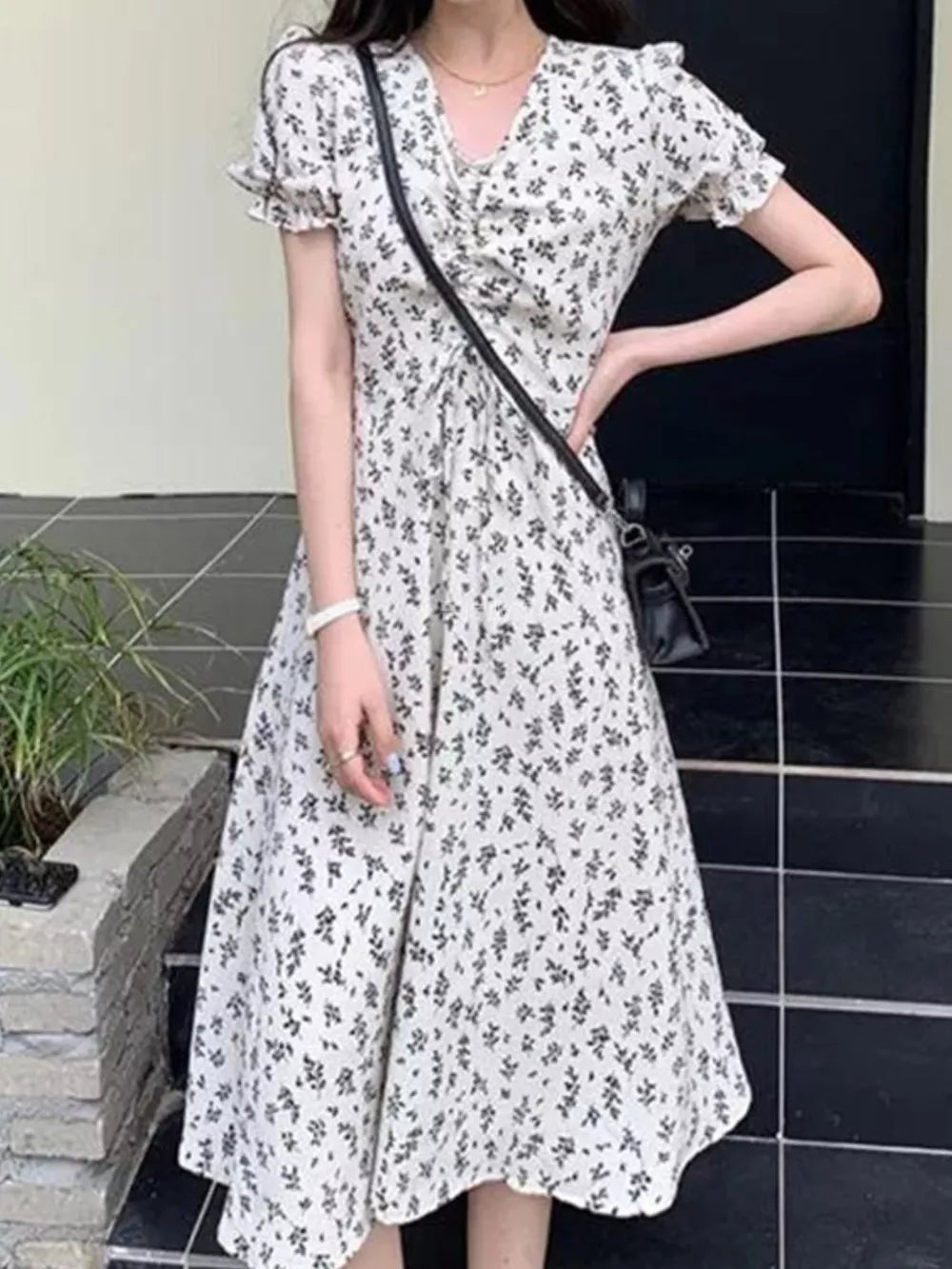 White botanical print midi dress with puff sleeves and a cinched waist