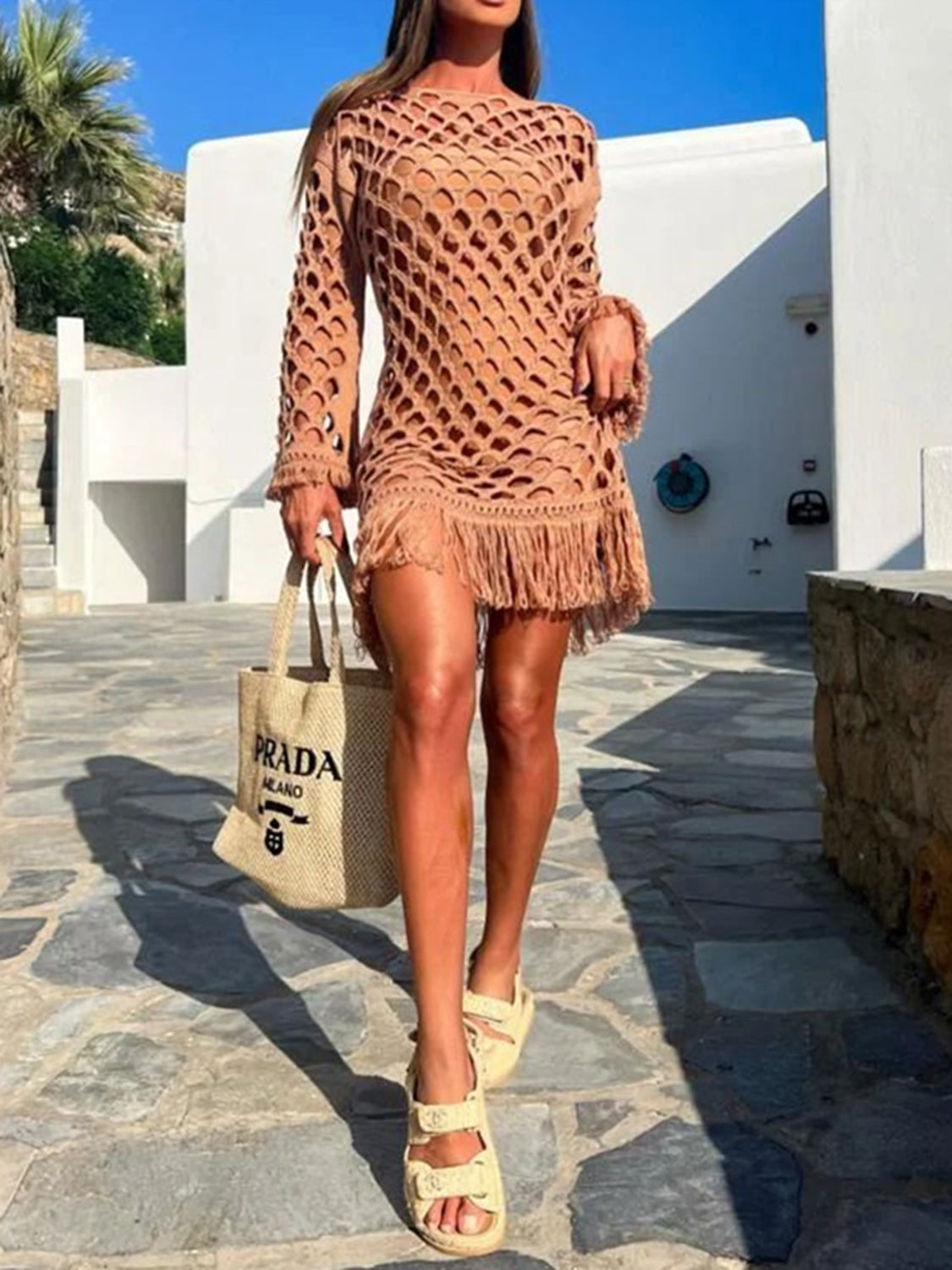 Caramel open-knit cover-up dress with fringe detail and long sleeves.
