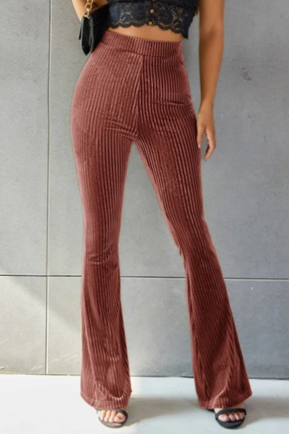 Ribbed velvet palazzo trousers in rust, with a high waist and flared leg.