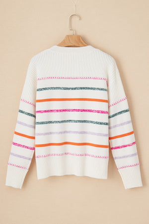 White ribbed knit pullover sweater with colorful horizontal stripes and crew neck.