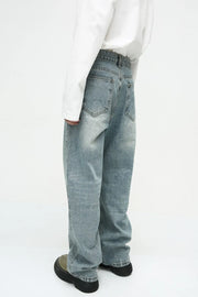 Baggy denim jeans in medium wash with subtle fade and relaxed fit.