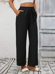Black relaxed drawstring wide-leg pants with pockets and elastic waistband.