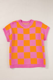 Checkerboard knit cap-sleeve top in pink and orange plaid with ribbed crew neck and hem.