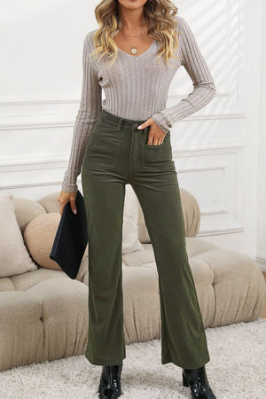 Olive corduroy flared leg trousers with front pockets, styled casually.