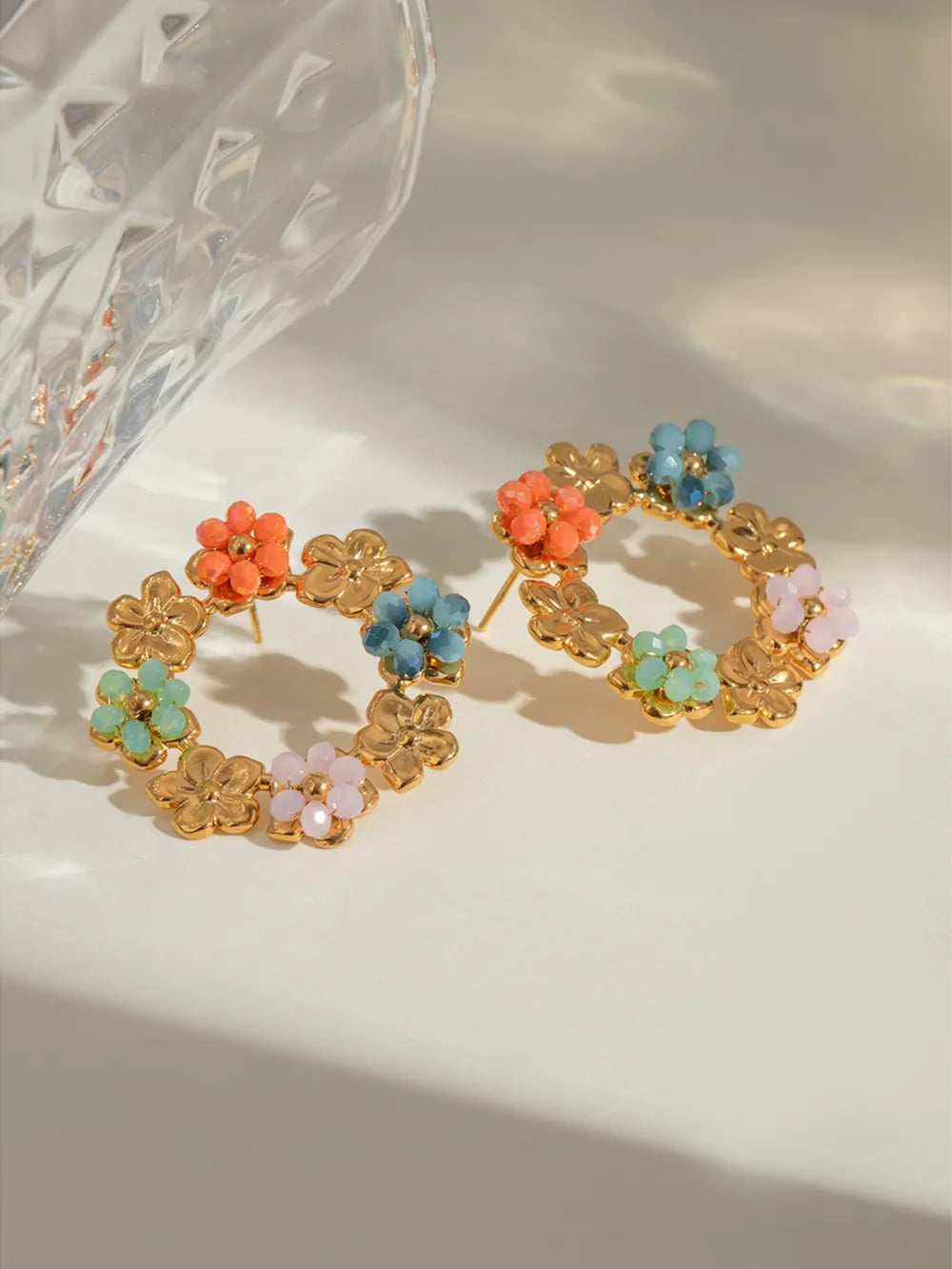Gold floral halo beaded earrings with colorful crystal flowers.