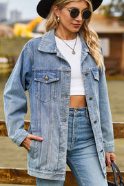 Oversized denim trucker jacket in medium wash with classic buttoned front and chest pockets.