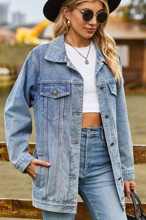 Oversized denim trucker jacket in medium wash with classic buttoned front and chest pockets.