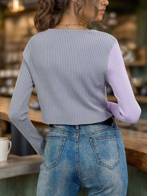 Colorblock ribbed cropped cardigan in lavender and grey, with long sleeves and a crew neck.