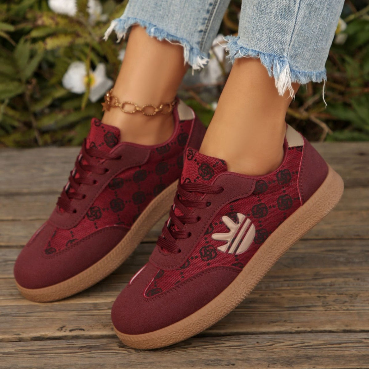 Round toe lace up sneakers in red with all over pattern and tan sole.