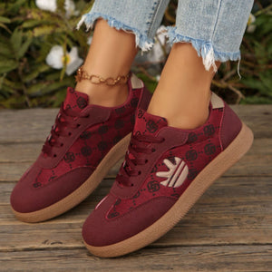 Round toe lace up sneakers in red with all over pattern and tan sole.