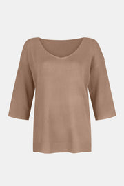 Tan knit sweater with V-neck and flared 3/4 sleeves.