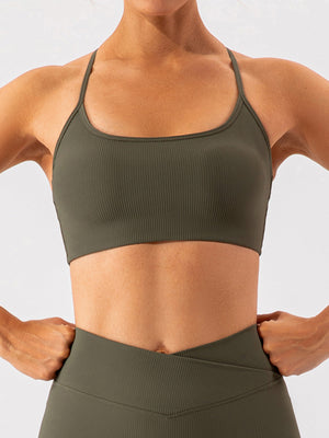 Ribbed halterneck active bra in matcha green with thin straps and a scoop neckline.