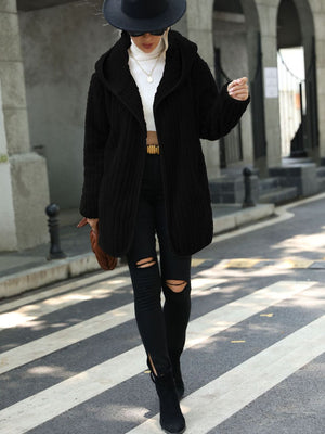 Black textured teddy hooded open coat with a relaxed fit, styled with ripped black jeans.