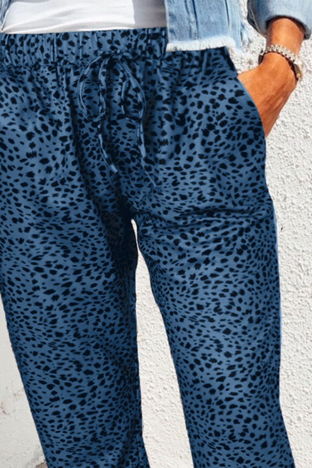 Peacock blue relaxed-fit drawstring trousers with a black shadow leopard print.