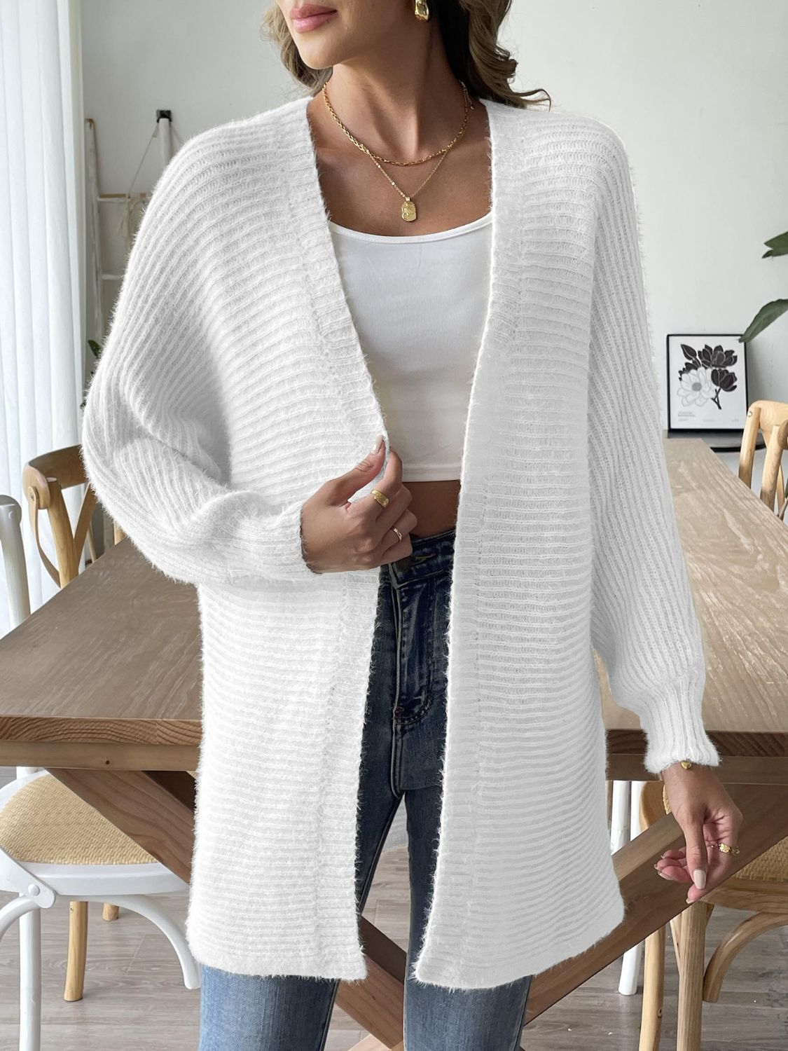 White ribbed knit dolman sleeve cardigan with open front and long sleeves.
