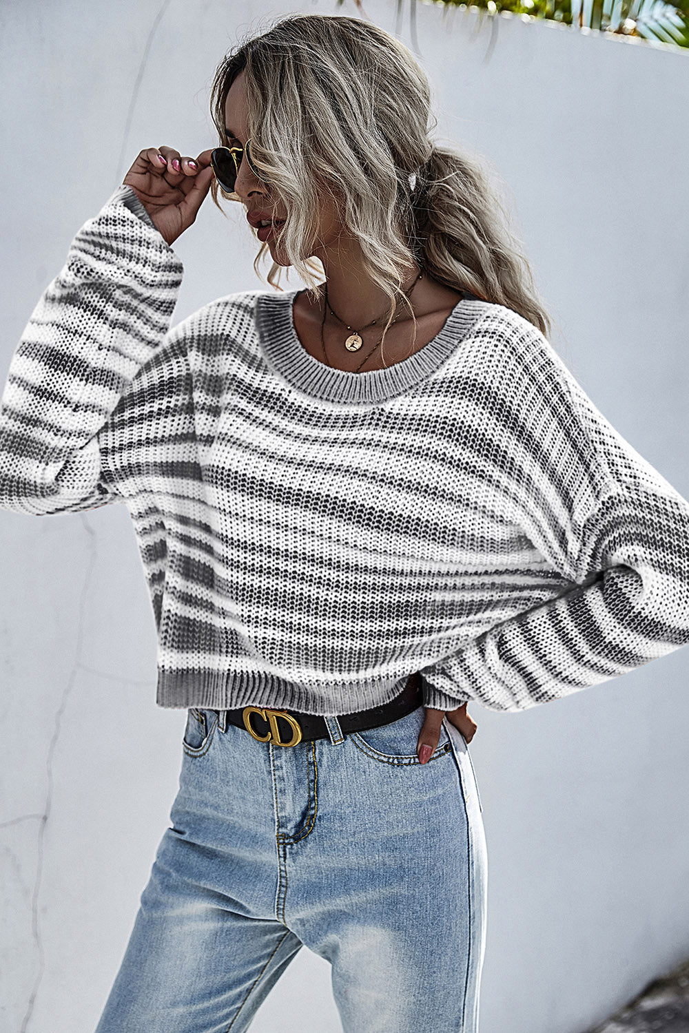 Cropped knit crew neck sweater with horizontal black and white stripes.