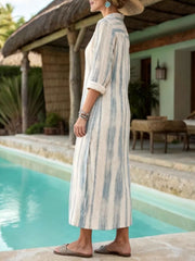 Button-down midi dress with blue vertical stripes, collared neckline, and cuffed sleeves.