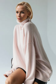 Oversized pink cashmere turtleneck sweater with relaxed fit and ribbed cuffs.