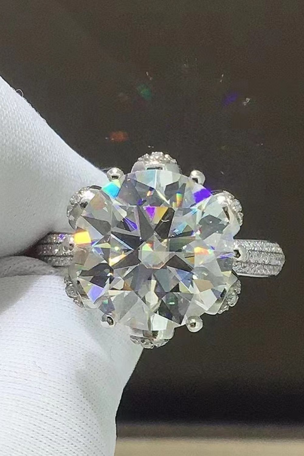 Sparkling Aura Moissanite Ring in silver with a large center stone and diamond-accented band.