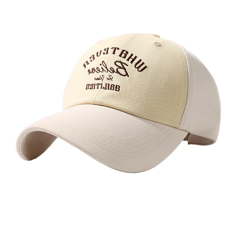 Embroidered two-tone baseball cap in beige and cream with brown text detail.