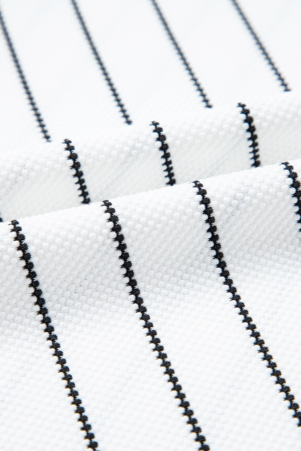 White blouse with black chevron stripes and textured fabric detail
