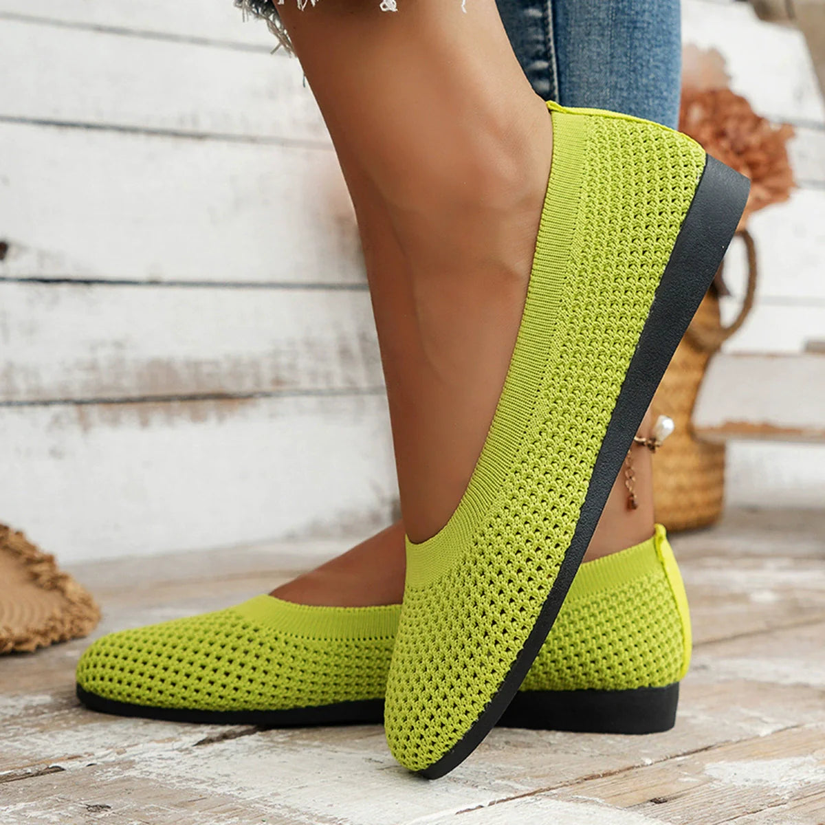 Lime breathable knit ballet flats with a black sole and perforated detail.