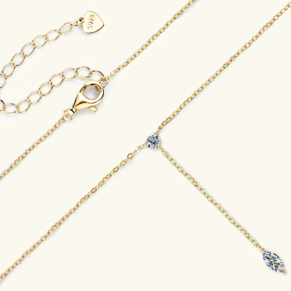 Gold lariat necklace with marquise moissanite pendant and adjustable clasp.