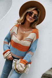 Deep plunge stripe knit pullover sweater with orange, cream, and blue stripes.