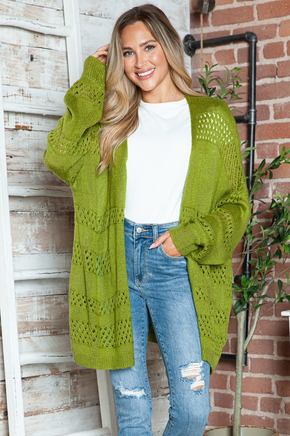 Open-knit slouchy cardigan in matcha green acrylic with openwork chevron details and relaxed fit.