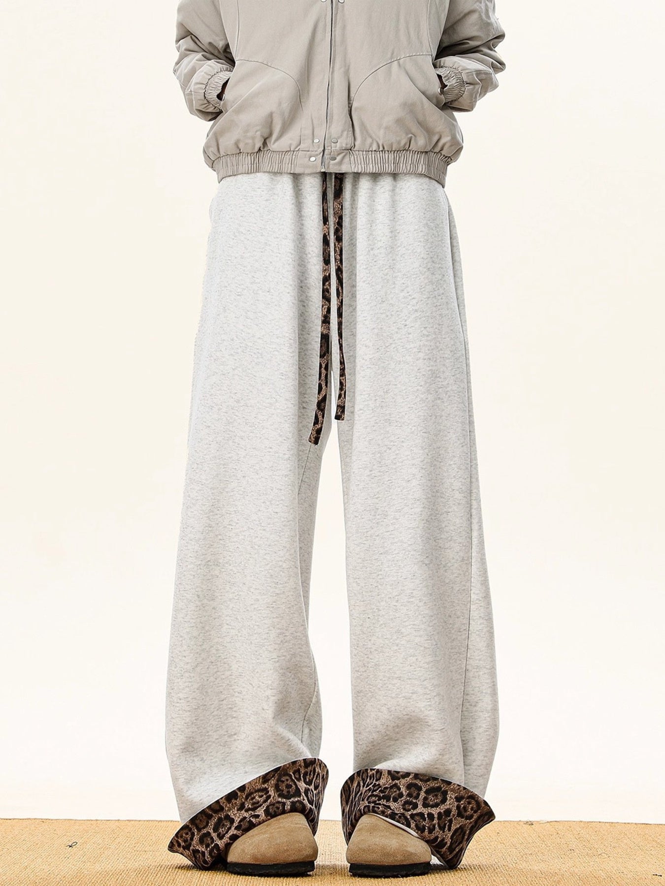 Gray sweatpants with leopard print trim on drawstring and cuffs.