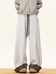 Gray sweatpants with leopard print trim on drawstring and cuffs.