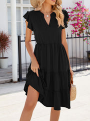 Black midi dress with ruffled short sleeves, notched V-neck, tiered skirt, and cinched waist.