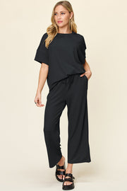 Black waffle knit loungewear set with short sleeves and drawstring pants.