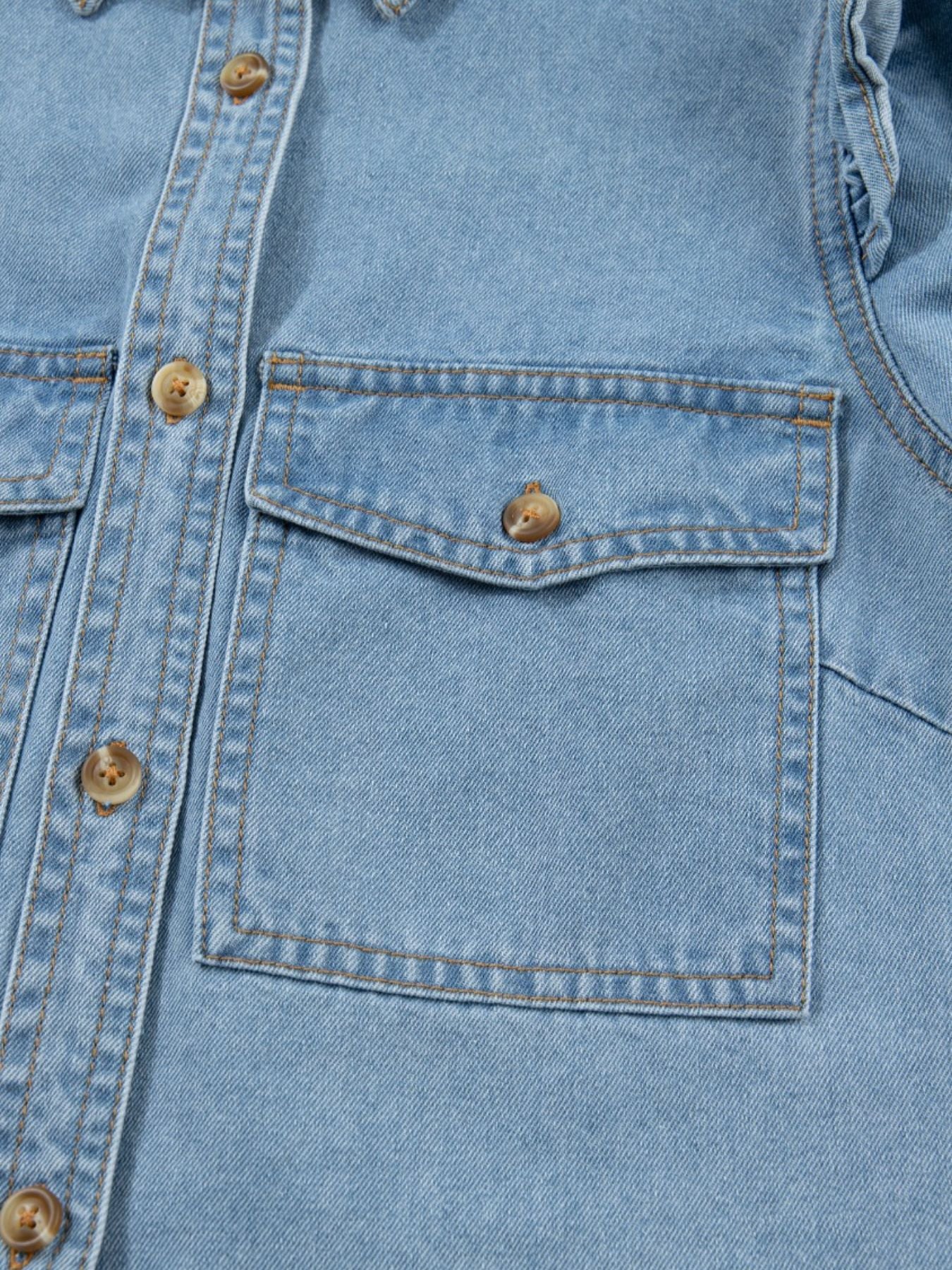 Light wash denim button-down shirt with two chest pockets and ruffled details.