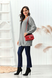 Gray cable knit open front cardigan with detailed sleeves.