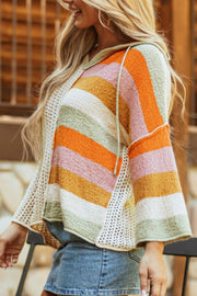 Colorblock knit hoodie with crochet side panels and bell sleeves.