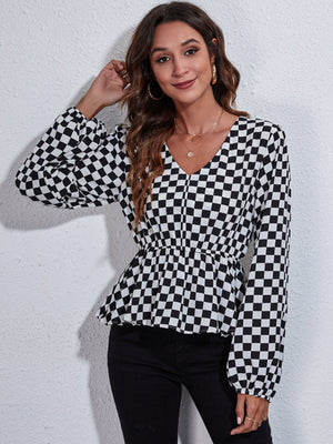 Gingham peplum blouse with V-neck, gathered waist, and bishop sleeves in black and white checkerboard pattern.