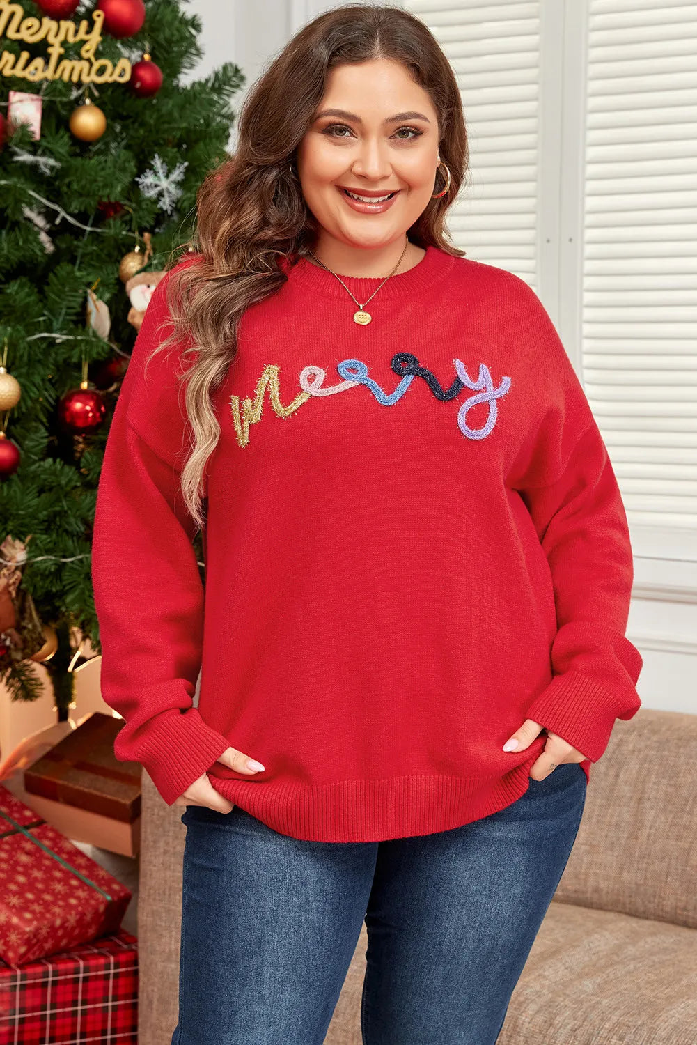 Red crewneck sweater with embroidered colorful "merry" text, casual knit style