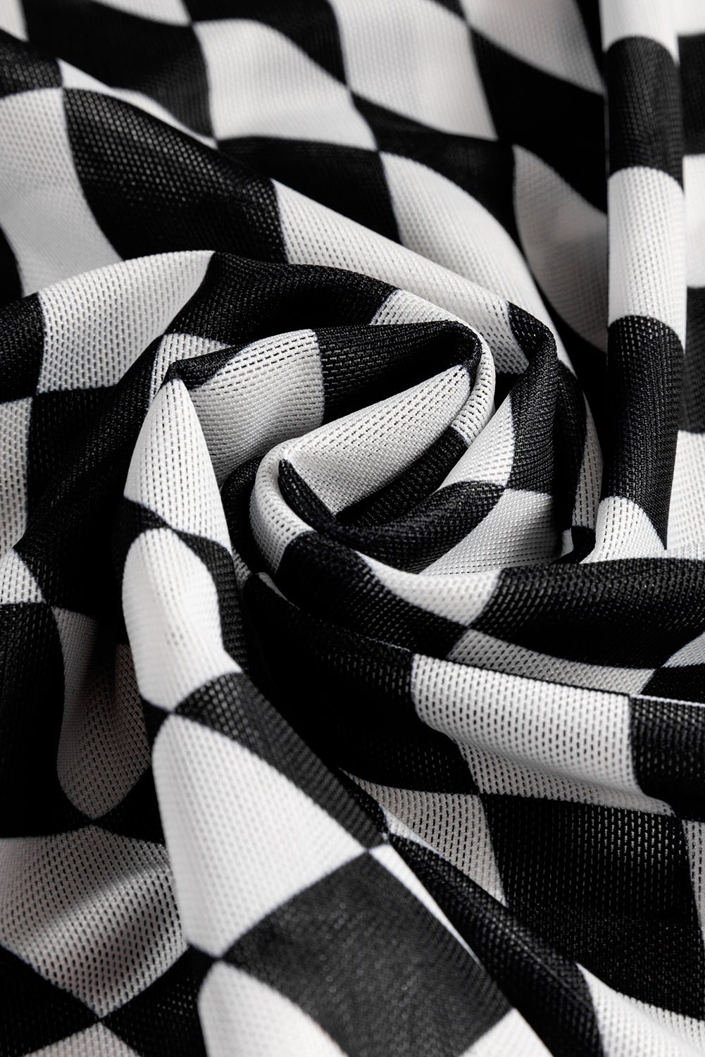 Black and white checkered mesh blouse with an optical illusion pattern.