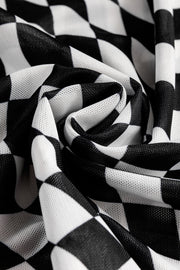 Black and white checkered mesh blouse with an optical illusion pattern.