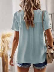 Light blue textured puff sleeve yoke top with short sleeves and a relaxed fit.